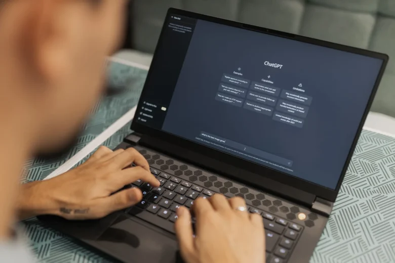 Pessoa digitando em um notebook enquanto usa um assistente de inteligência artificial no dia a dia